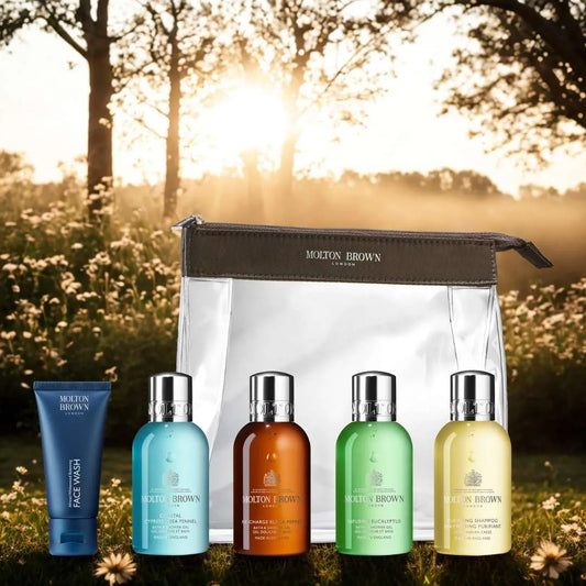 Molton Brown men's carry on toiletries set with travel-sized face wash and shower gels in a clear bag
