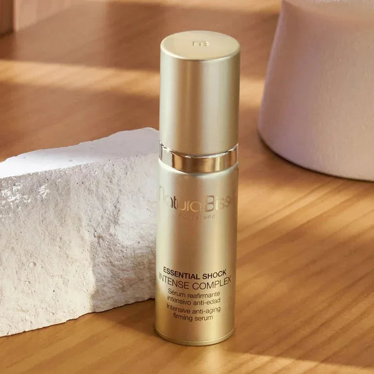 Natura Bissé Essential Shock Intense Complex Anti-Aging Firming Serum in a sleek gold bottle