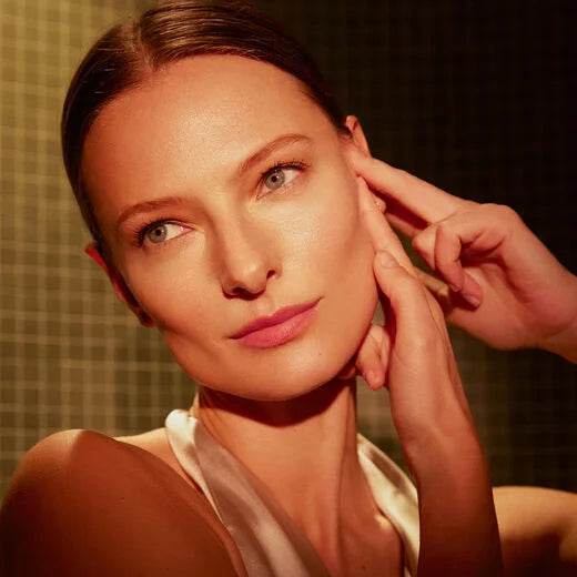 Model showcasing Natura Bissé Anti-Aging Hydrating Serum applied on glowing skin