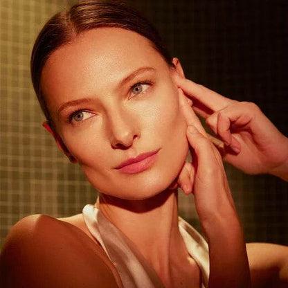 Model showcasing Natura Bissé Anti-Aging Hydrating Serum applied on glowing skin