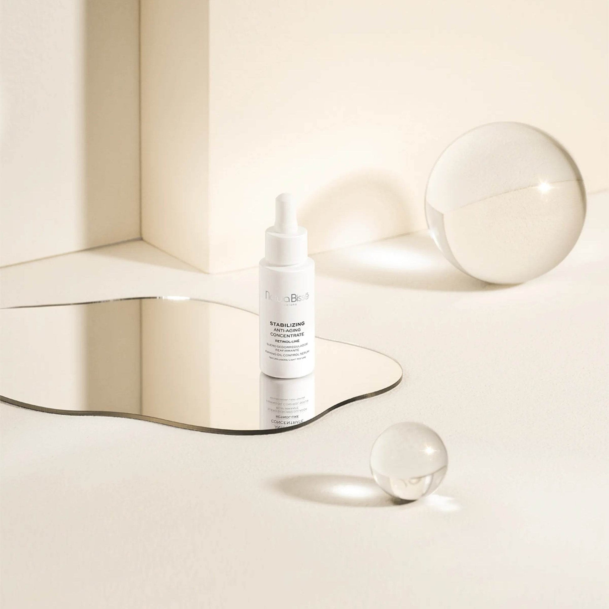 Natura Bissé Blemish, Oil, and Pore Control Serum bottle on a reflective surface with minimalist design