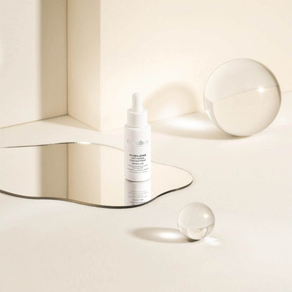 Natura Bissé Blemish, Oil, and Pore Control Serum bottle on a reflective surface with minimalist design