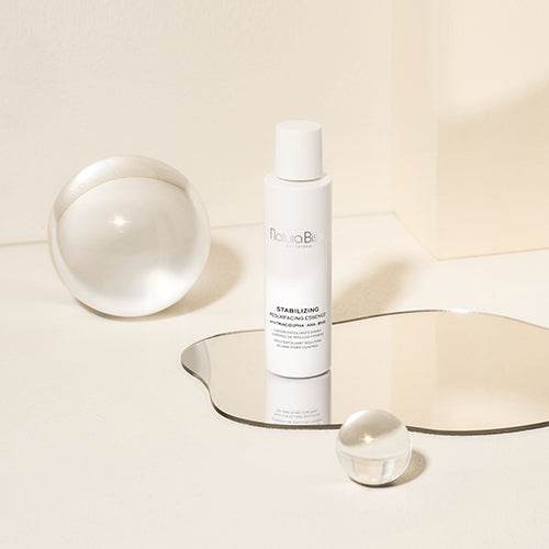 Natura Bissé Daily Exfoliant Solution in a sleek bottle with minimalist design and reflective elements