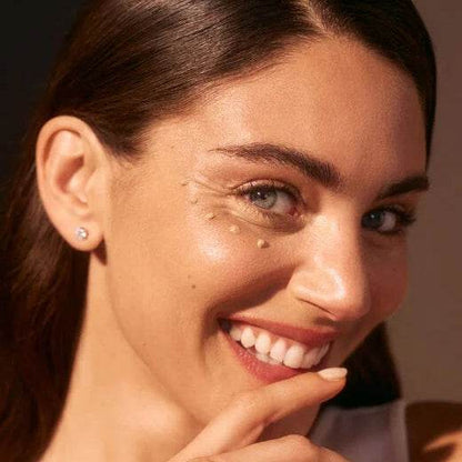 Model showcasing radiant skin and bright smile, featuring Diamond Cocoon Sheer Holiday Set skincare products