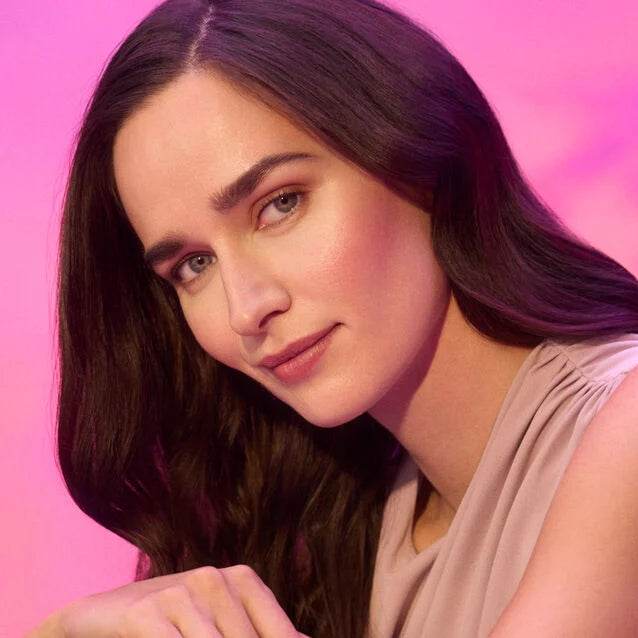 Model showcasing radiant skin using Natura Bissé Hydrating Revitalizing Essence for a glowing complexion.