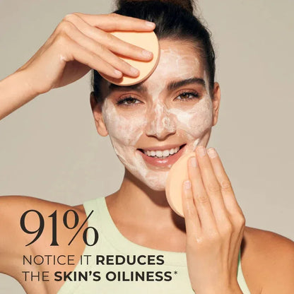 Woman applying Natura Bissé Purifying and Deep Cleansing Mask to her face with a cleansing sponge