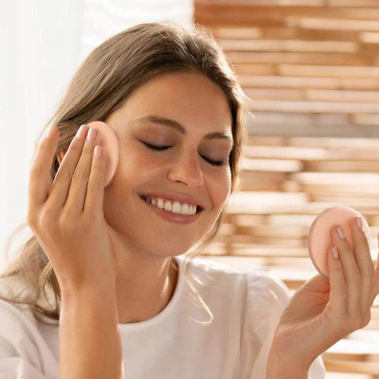 Natura Bisse Revitalizing cleanser and makeup remover being applied on a woman's face for a refreshed look