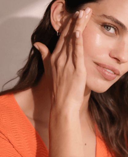 Model applying Natura Bisse Vitamin C Cream for radiant and youthful skin