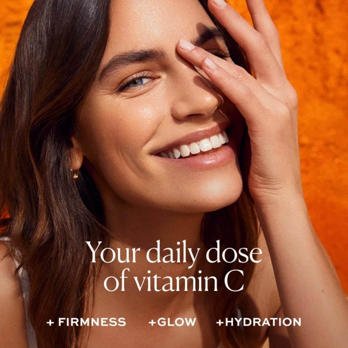 Natura Bisse Vitamin C Cream promoting firmness, glow, and hydration with a smiling model