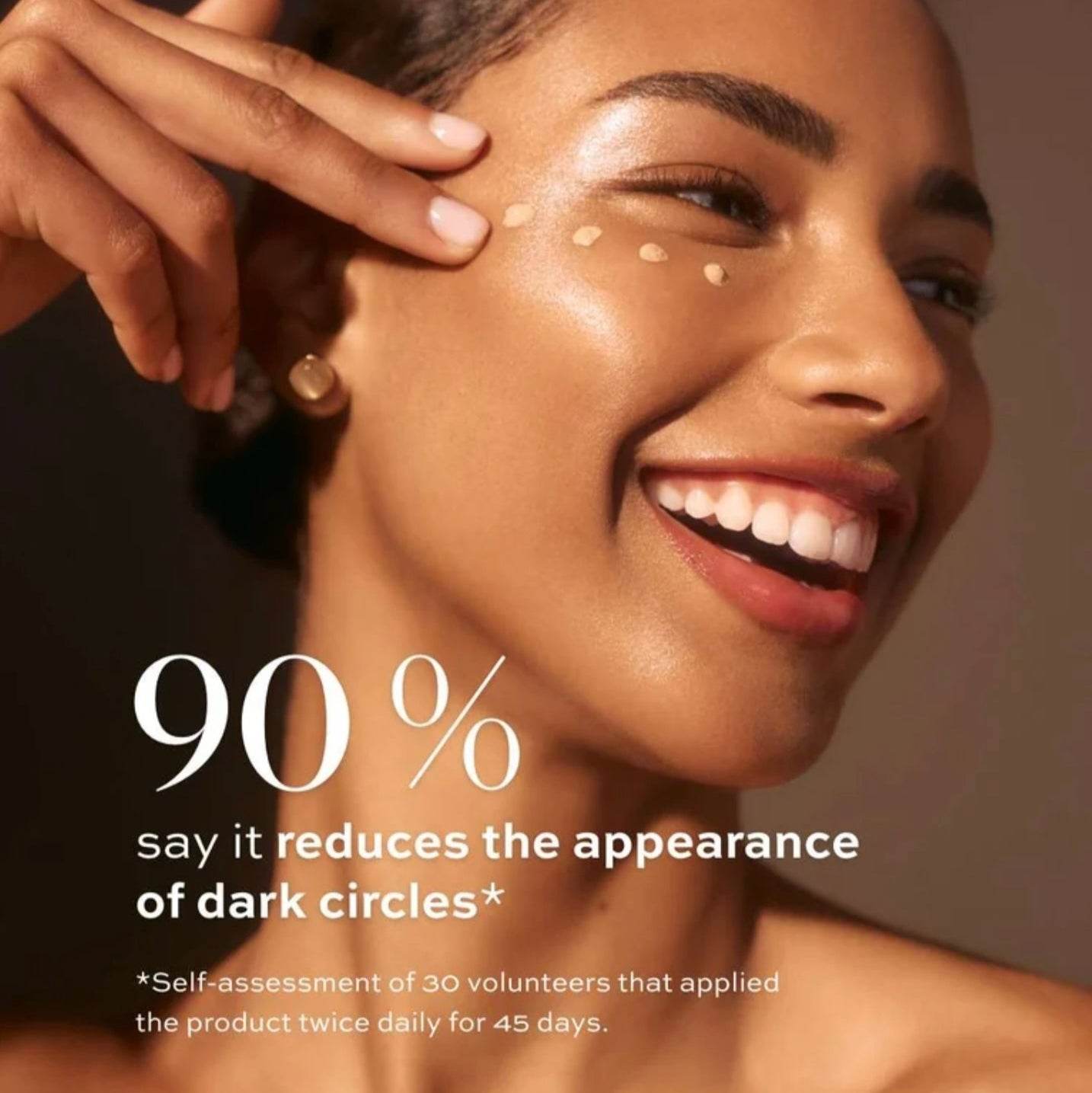 Natura Bisse Tinted Eye Cream applied under the eye to reduce dark circles with glowing skin