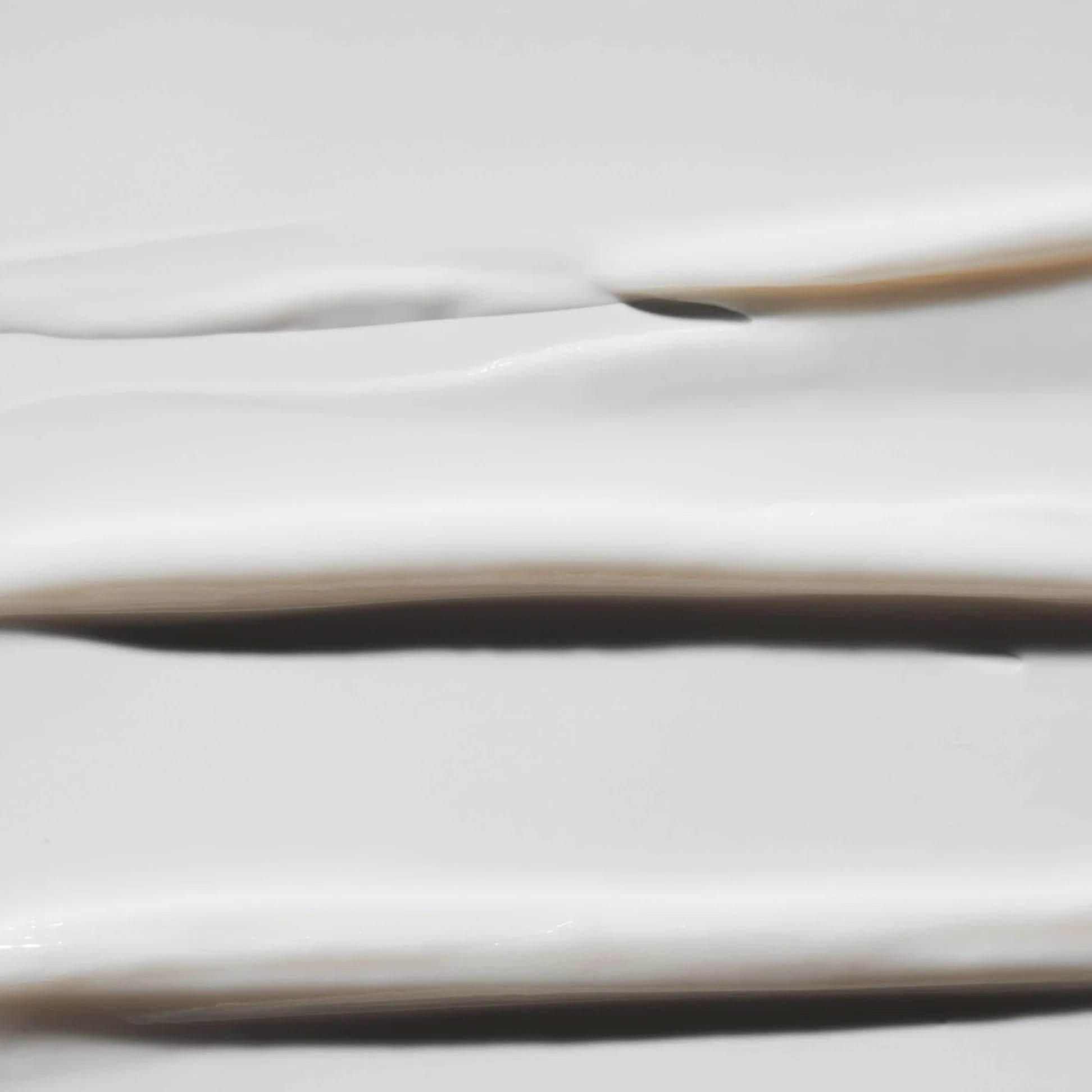 Smooth texture of Omorovicza Eye Lift Eye Cream on a white surface for rejuvenated skin