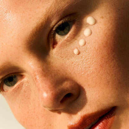 Omorovicza Vitamin C eye cream applied under the eye with a close-up of the product