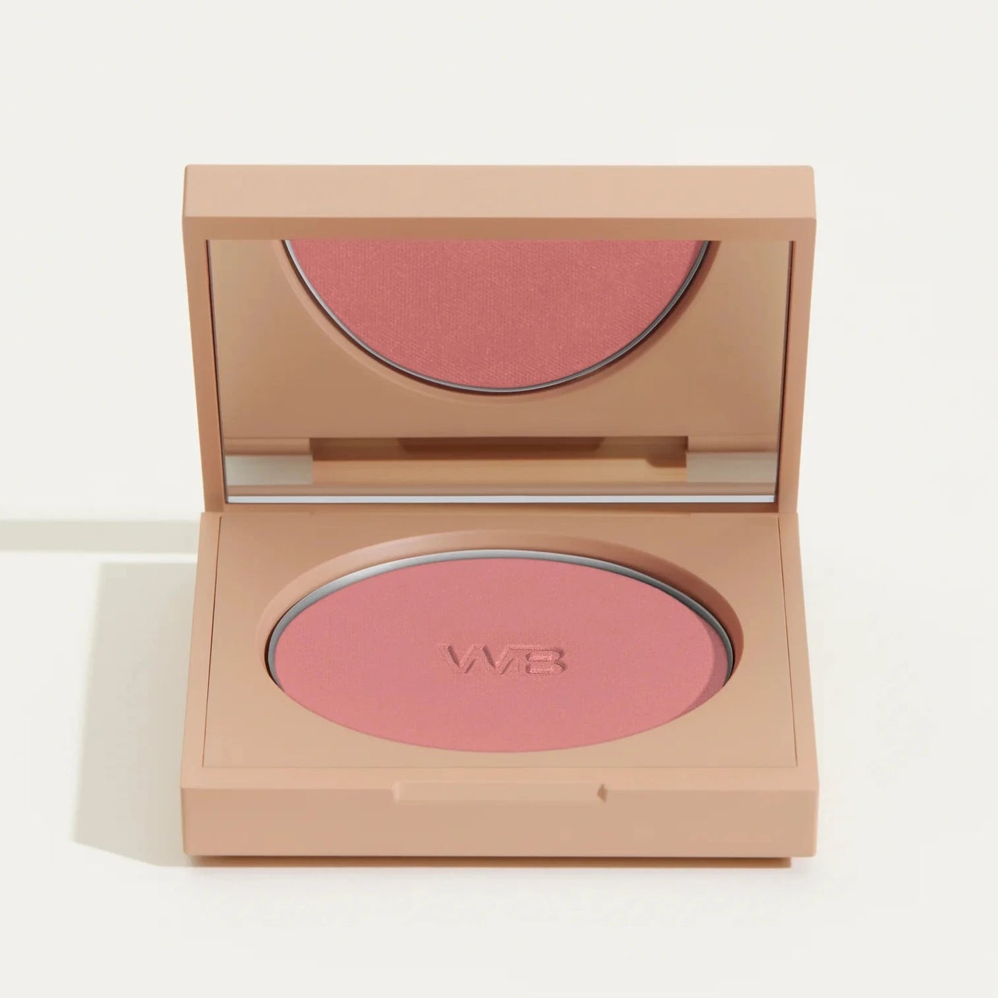 Wonderblush Powder Blush in soft pink shade, inside a compact with mirror for easy application