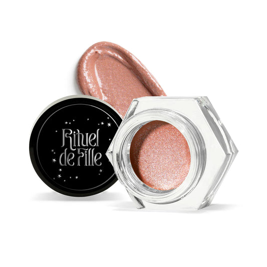 Rituel de Fille Eye Gloss in a hexagonal jar with a shimmering rose gold hue swatch