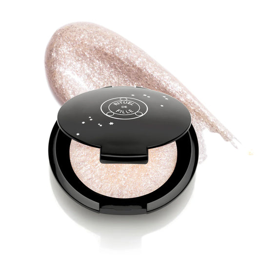 Rituel de Fille Highlight Intensifier in a compact with shimmering silver formula for radiant skin