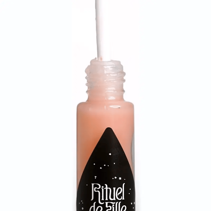 Rituel de Fille Lip Oil in a transparent tube with a doe-foot applicator for glossy lips