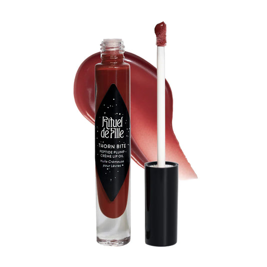 Rituel de Fille Thorn Bite Lip Oil in a dark red shade with a doe-foot applicator