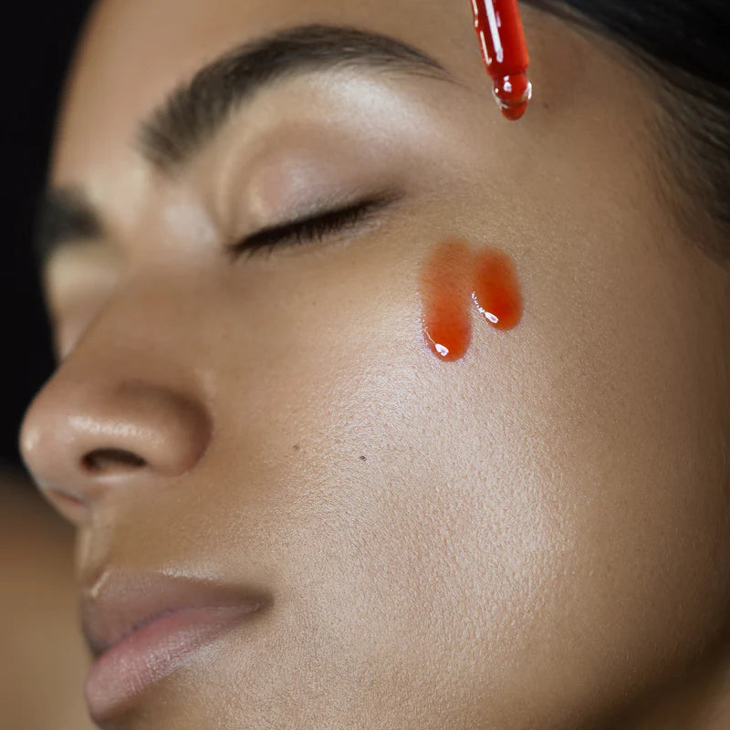 Rituel de Fille Priming Facial Elixir being applied to skin for a radiant glow