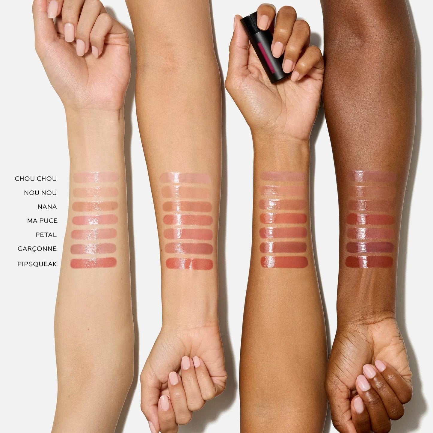 Swatches of Westman Atelier Tinted Lip Balm shades on different skin tones showcasing a variety of colors