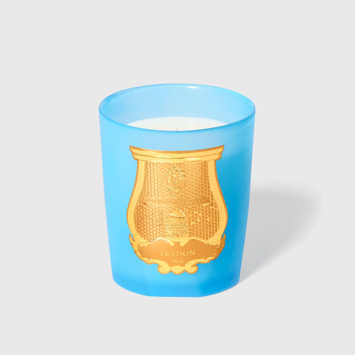 Versailles Candle in a blue glass container with gold emblem by London Beauty
