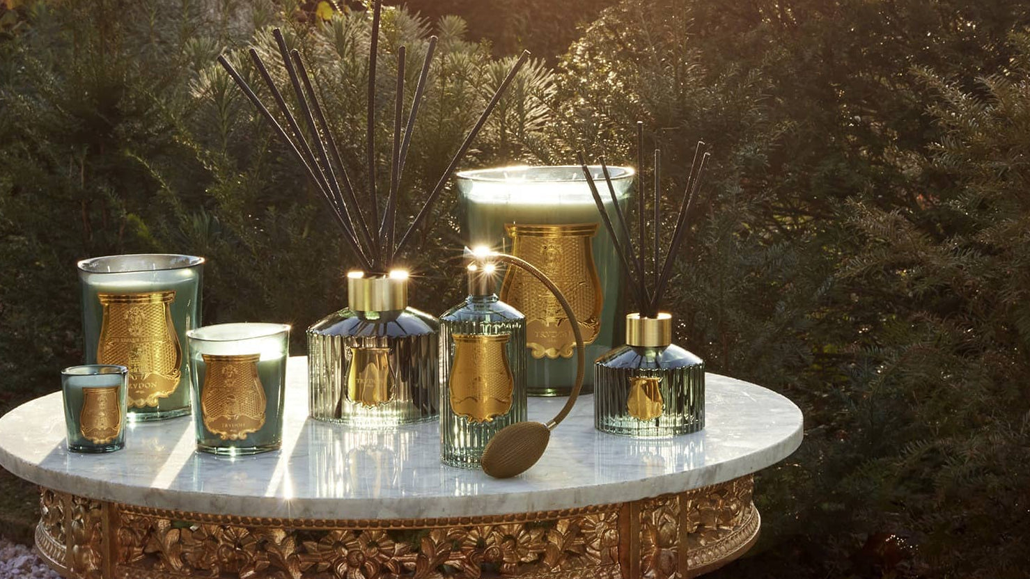 Decorative table with candles and vases in a garden setting
