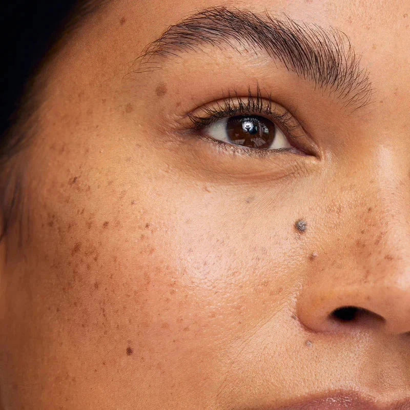 Close-up of a model's face showcasing glowing skin using Westman Atelier Powder Bronzer