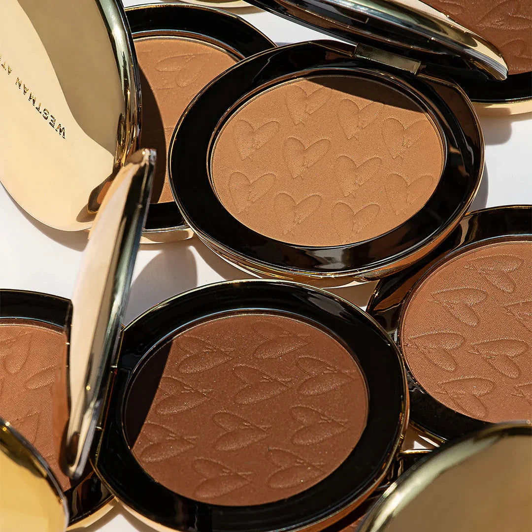 Westman Atelier Powder Bronzer in multiple shades with heart-embellished powder surface