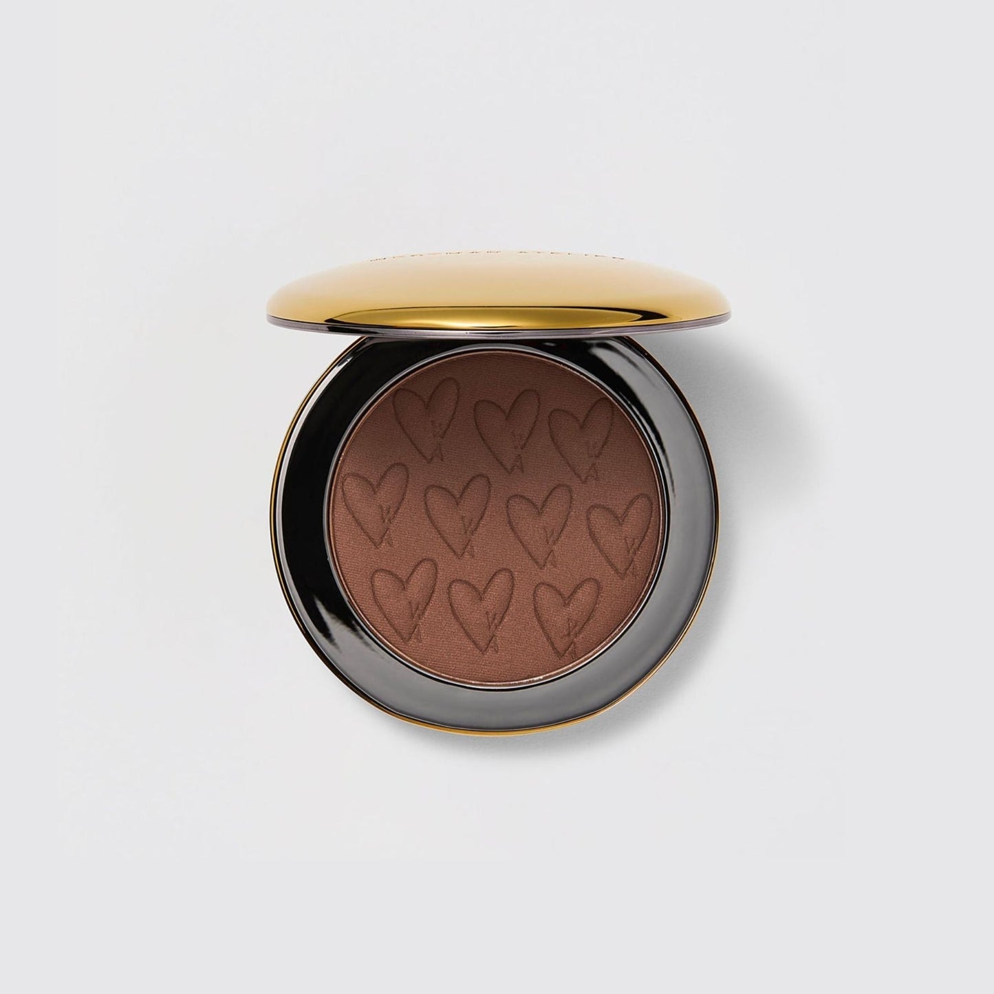 Westman Atelier Powder Bronzer in a compact with heart-shaped design for a radiant glow