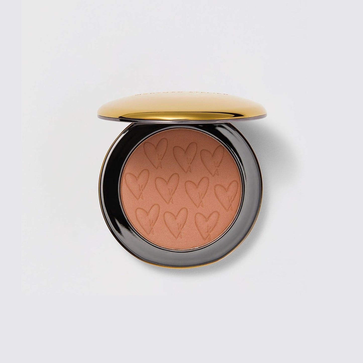 Westman Atelier Powder Bronzer in a sleek compact with heart design, perfect for a sun-kissed glow