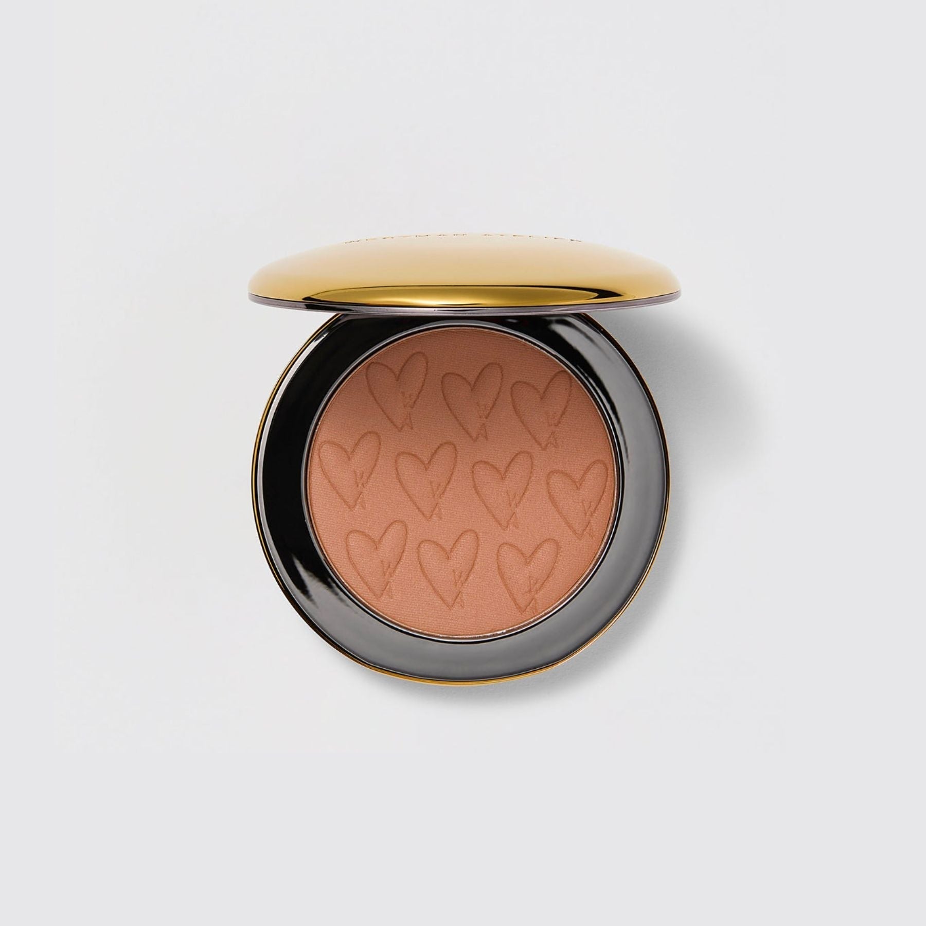 Westman Atelier Powder Bronzer in a sleek compact with heart design, perfect for a sun-kissed glow