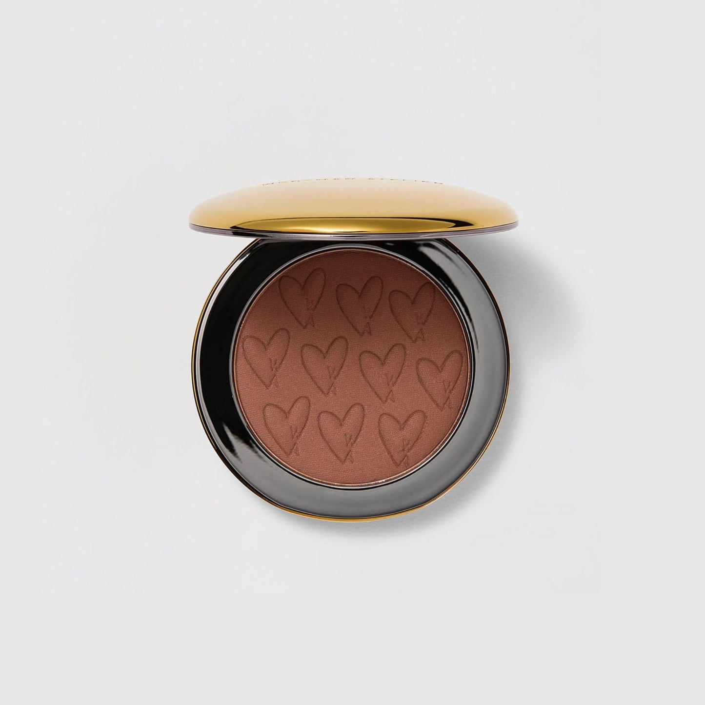 Westman Atelier Powder Bronzer in a sleek compact with heart design for a warm, sun-kissed glow