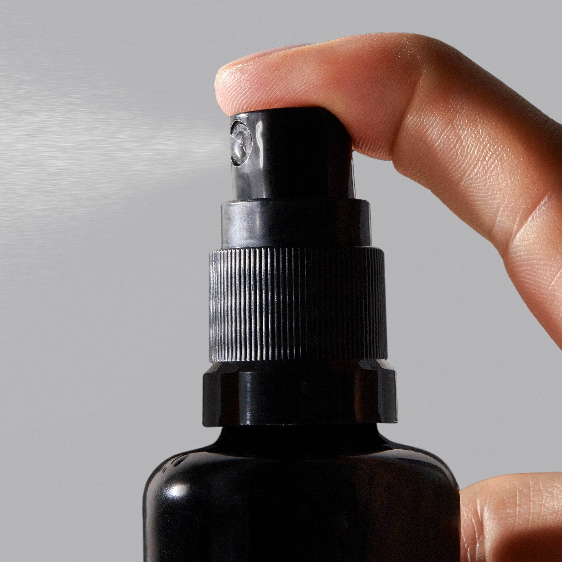 Vintner's Daughter black spray bottle dispensing Illuminating and Renewing Hydration mist