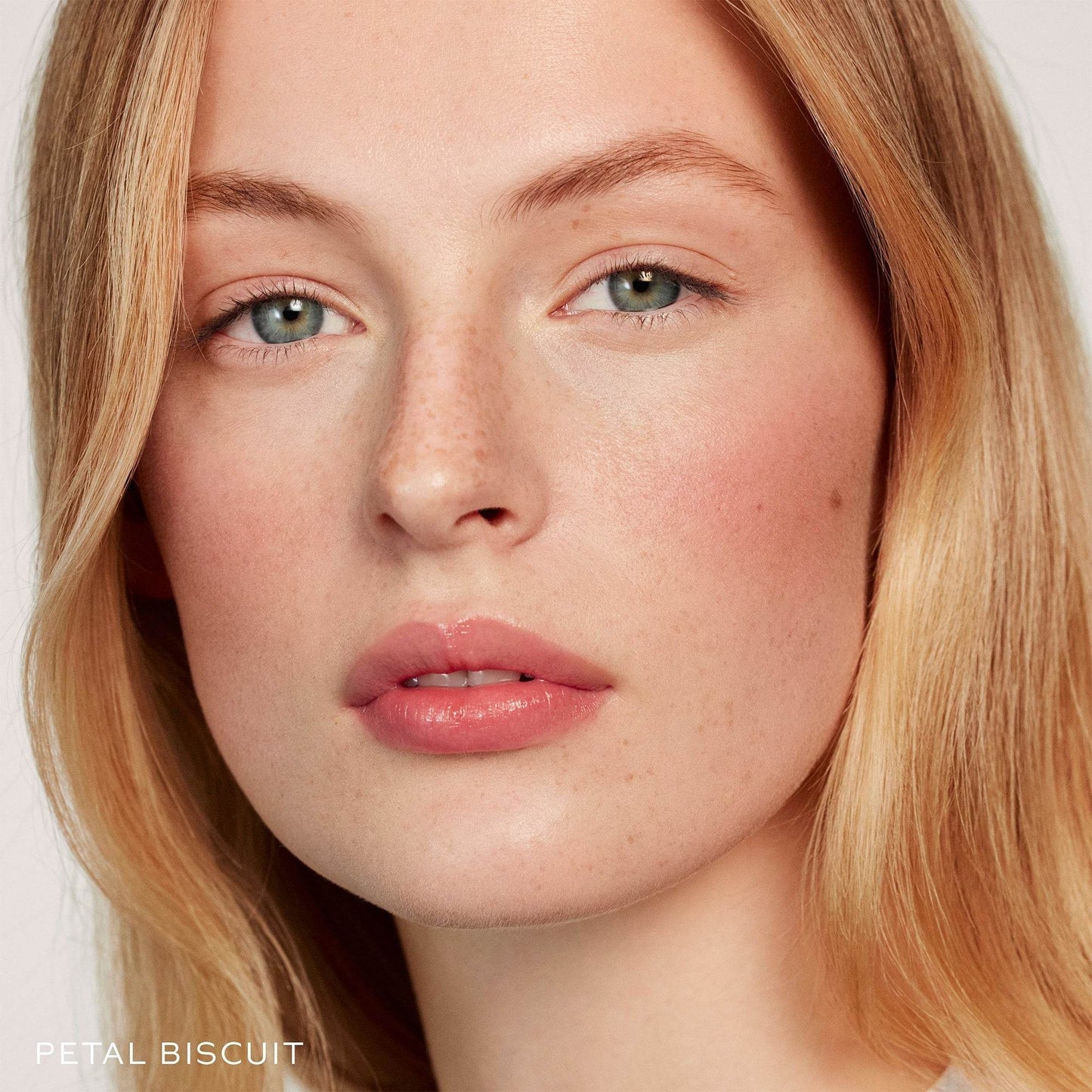 Close-up of a model showcasing natural makeup using Blush and Sculpt Powder Duos for a radiant look