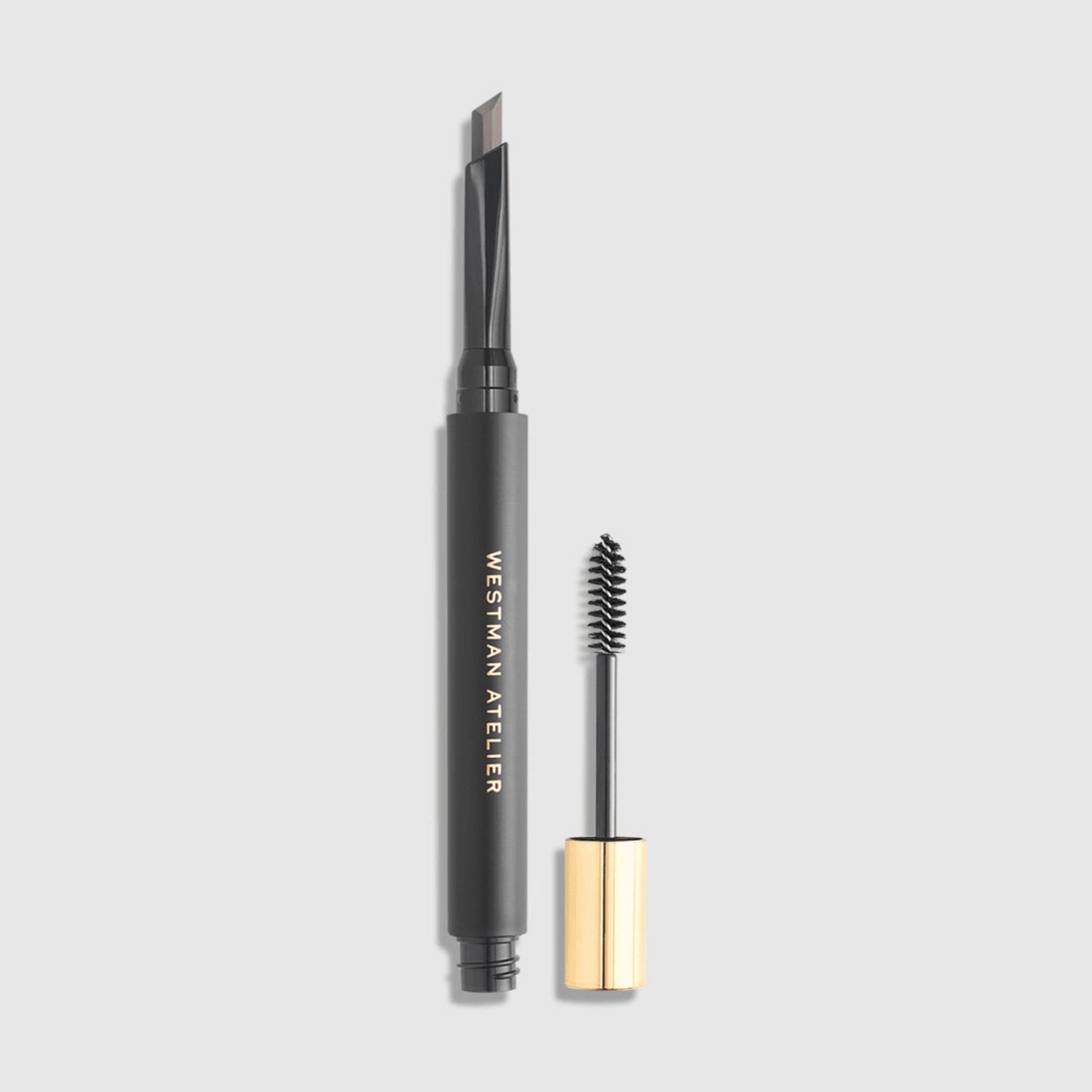 Westman Atelier Brow Defining Pencil in Gray with a brush for precise eyebrow shaping