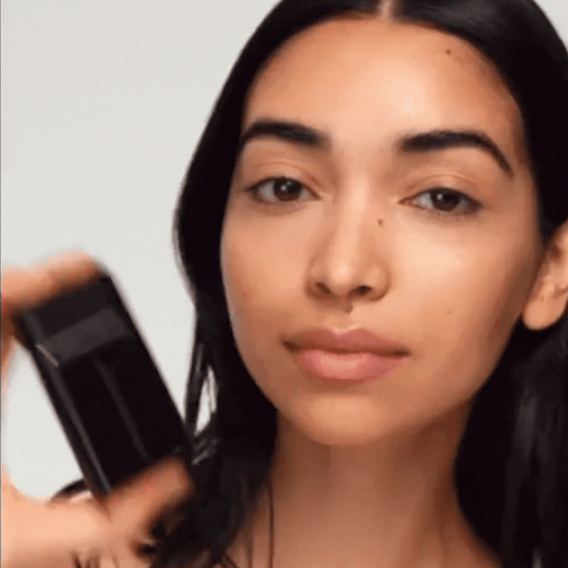 Westman Atelier Liquid Highlight being applied on a model's cheek for a radiant glow