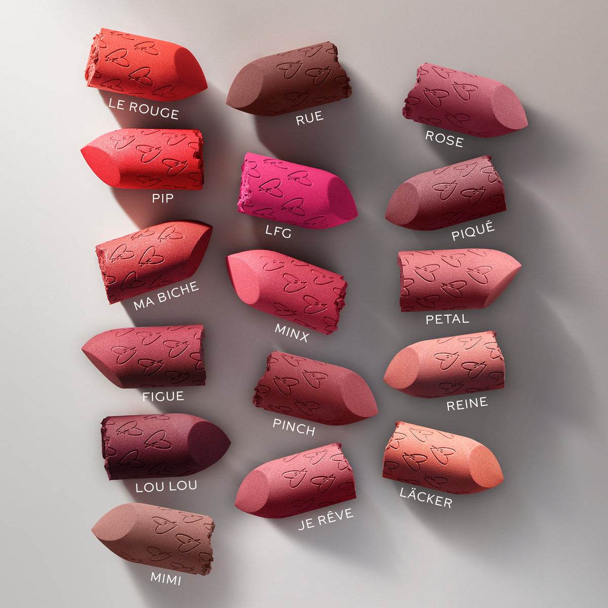 Variety of Westman Atelier Luxury Matte Lipstick shades arranged elegantly in a colorful display
