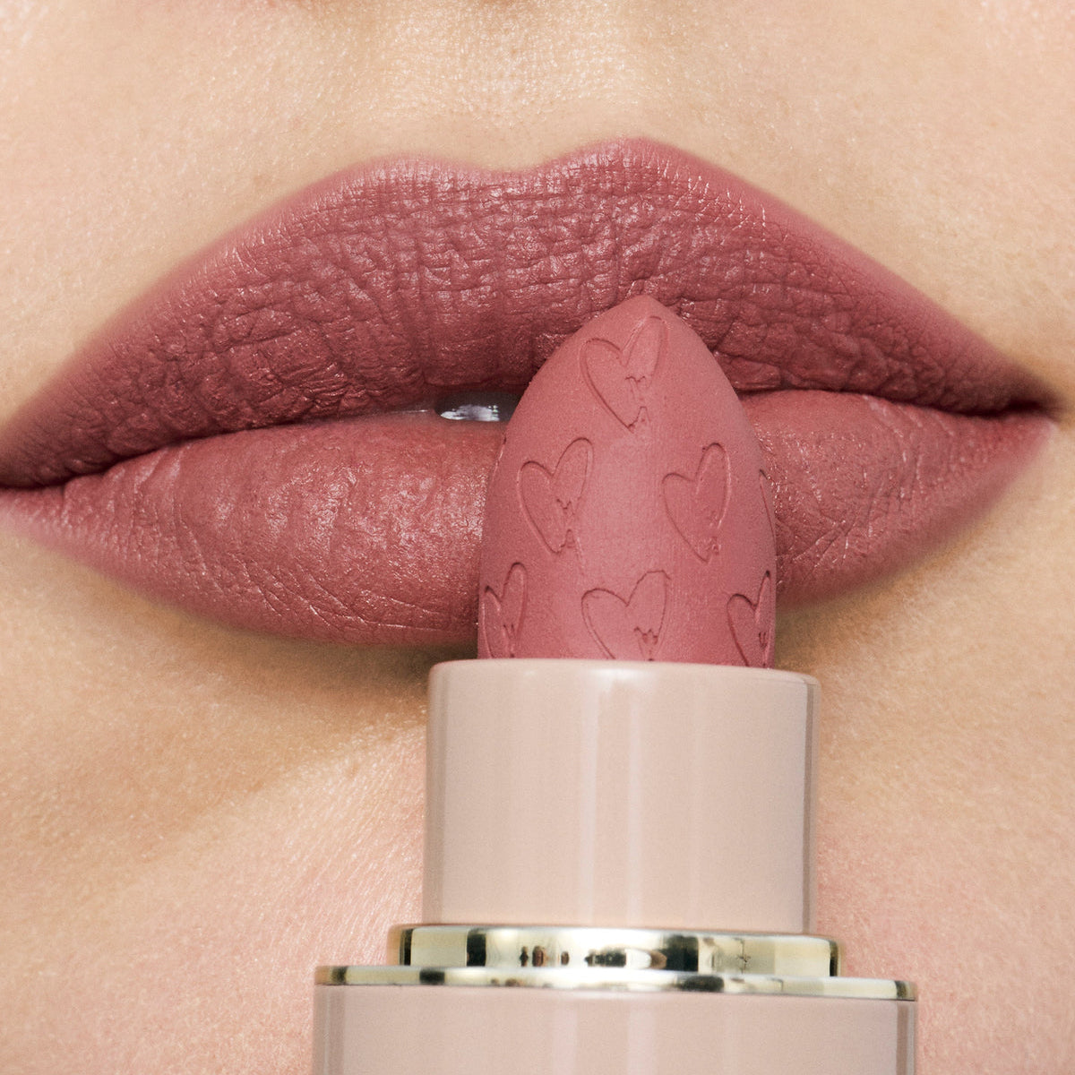 Westman Atelier Luxury Matte Lipstick in a soft nude shade with heart-embossed bullet design