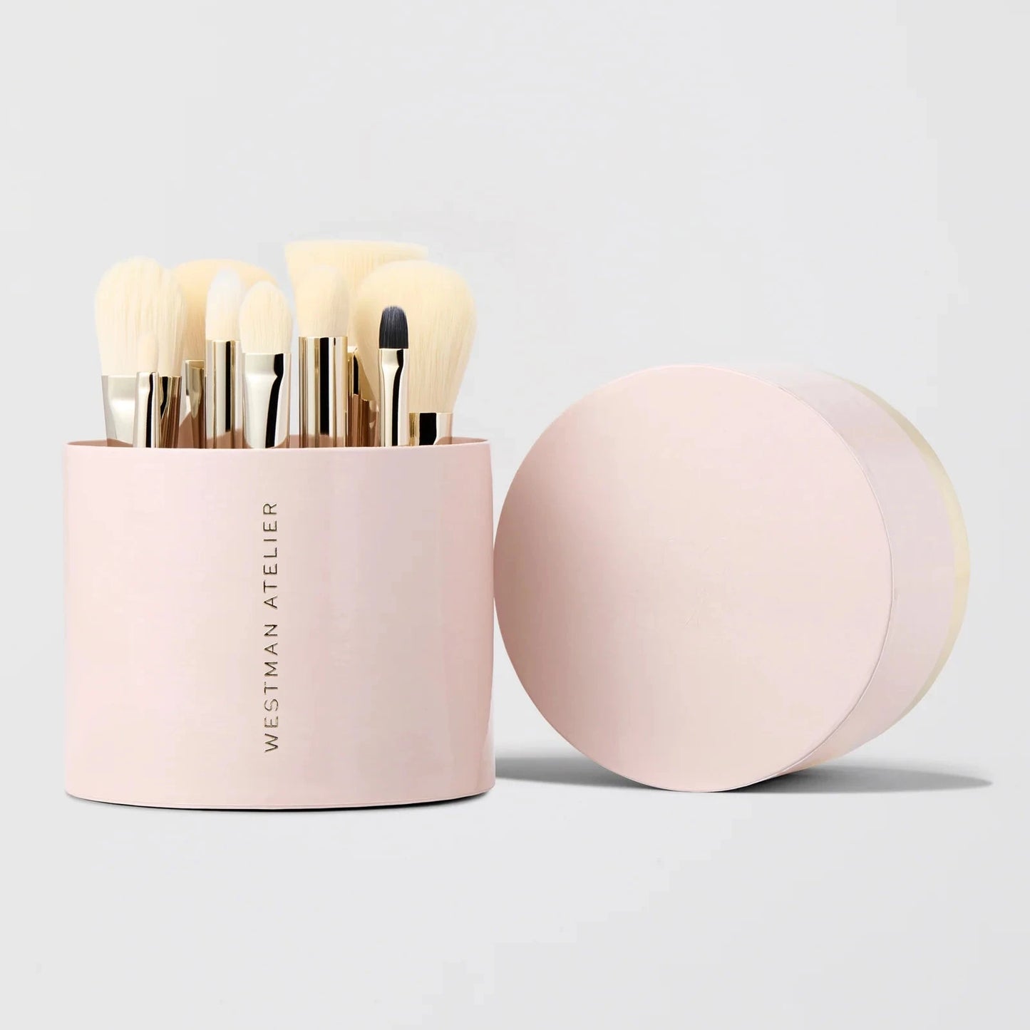 Westman Atelier Petite Brush Collection in a round pink container with various makeup brushes