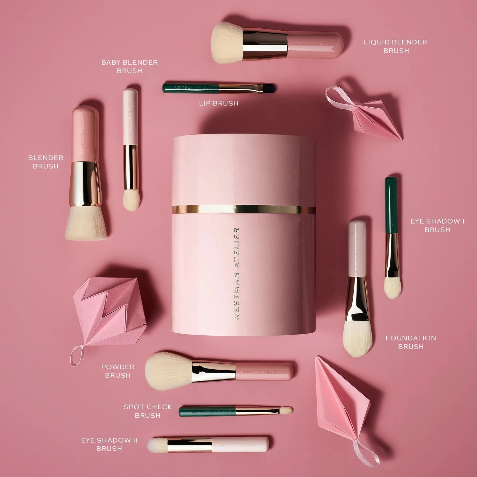 Westman Atelier Petite Brush Collection featuring various makeup brushes on a pink background
