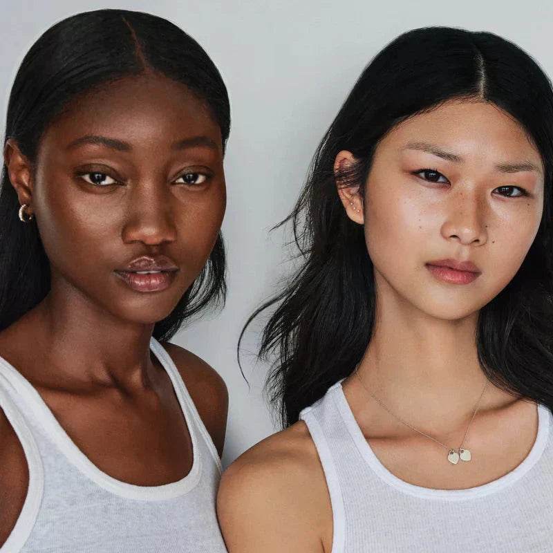 Two models showcasing natural beauty with Westman Atelier Radiant Skin Tint for a flawless complexion