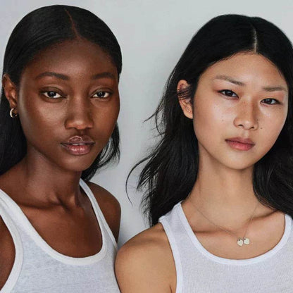 Two models showcasing natural beauty with Westman Atelier Radiant Skin Tint for a flawless complexion