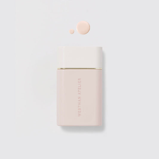 Westman Atelier Radiant Skin Tint in a sleek container with a drop of product for glowing skin