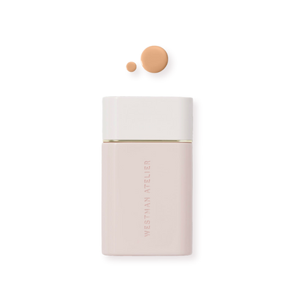 Westman Atelier Radiant Skin Tint in a sleek bottle with a drop of tint above for glowing complexion