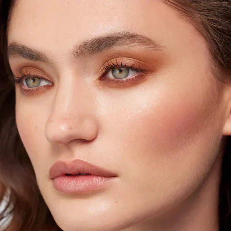 Model showcasing Westman Atelier Cream Eyeshadow in a natural makeup look with earthy tones