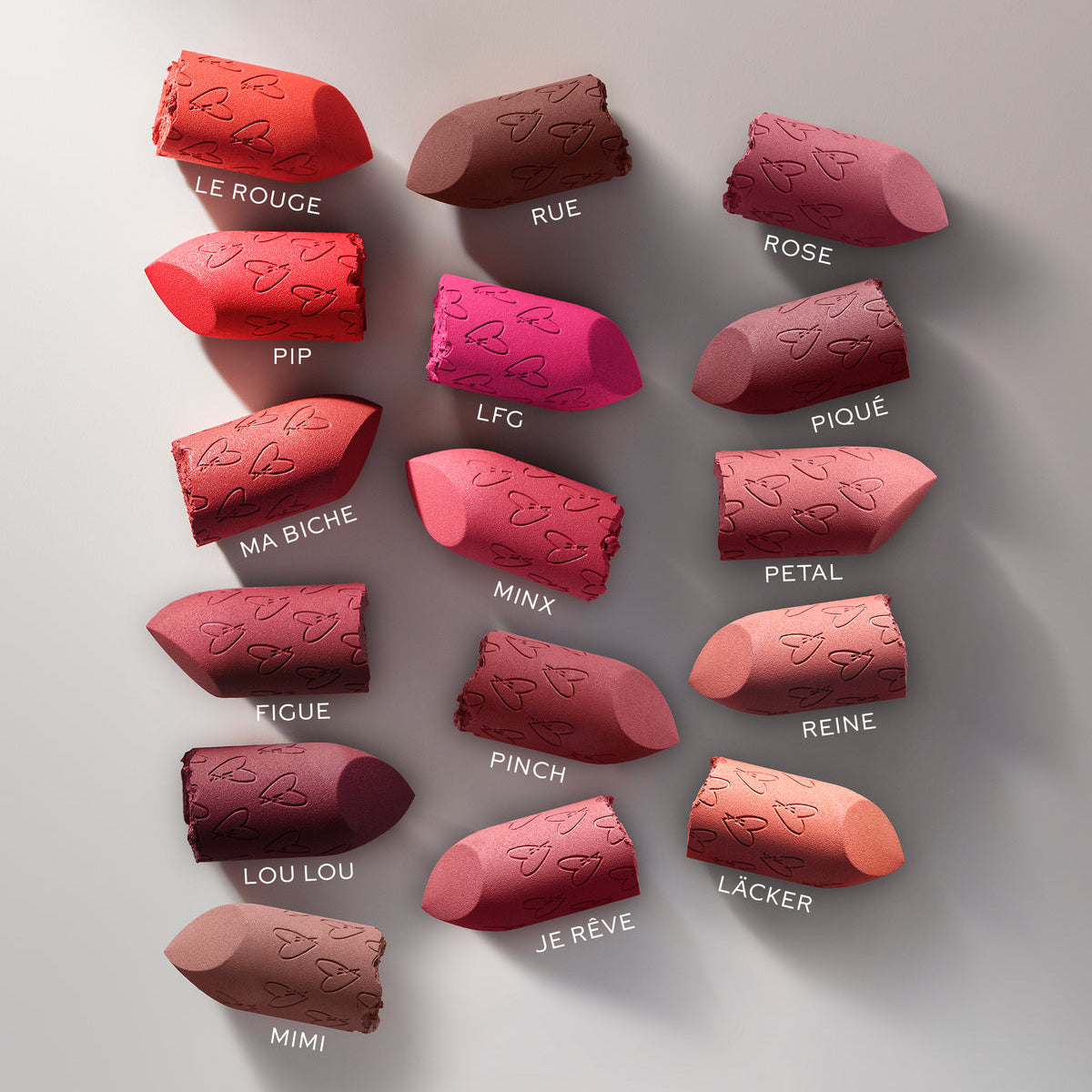 Variety of Westman Atelier Comfortable Matte Lipstick shades displayed on a neutral background