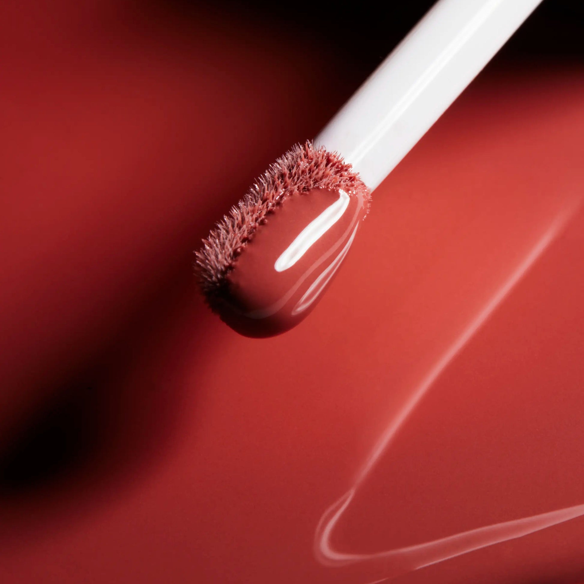 Wonderblush Tinted Lip Oil in a rich red shade with a soft applicator for easy application
