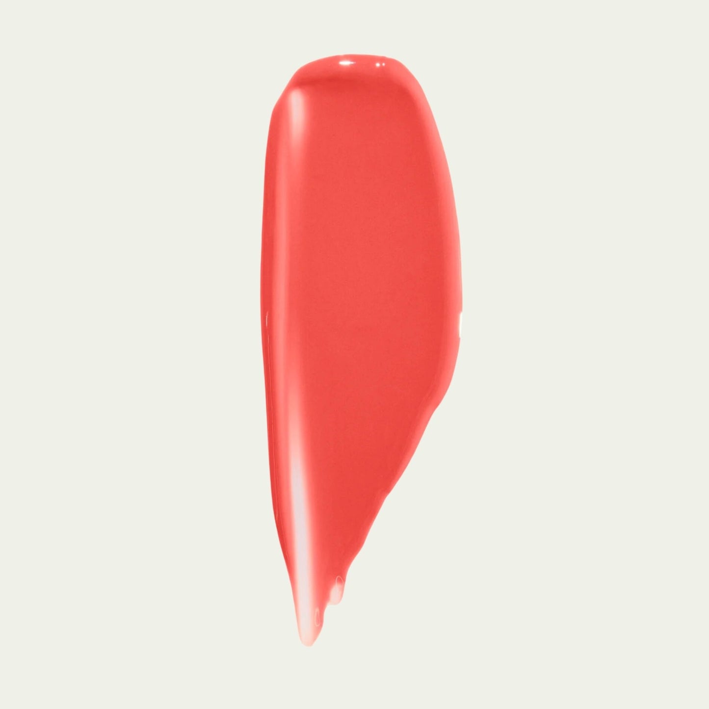 Wonderblush Tinted Lip Oil swatch in a coral shade, offering a hydrating and glossy finish